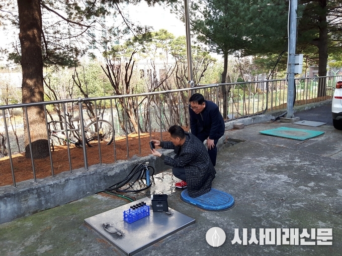 수돗물 평가위원회 위원(오른쪽)이 참관한 가운데, 수원시 상수도사업소 관계자가 채수 작업을 하고 있다. 