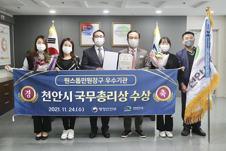 천안시가 행정안전부 ‘2021년 원스톱방문 민원창구 우수기관’에 선정돼 박상돈 천안시장과 송재열 허가과장, 허가과 직원들이 기념사진을 찍고 있다.