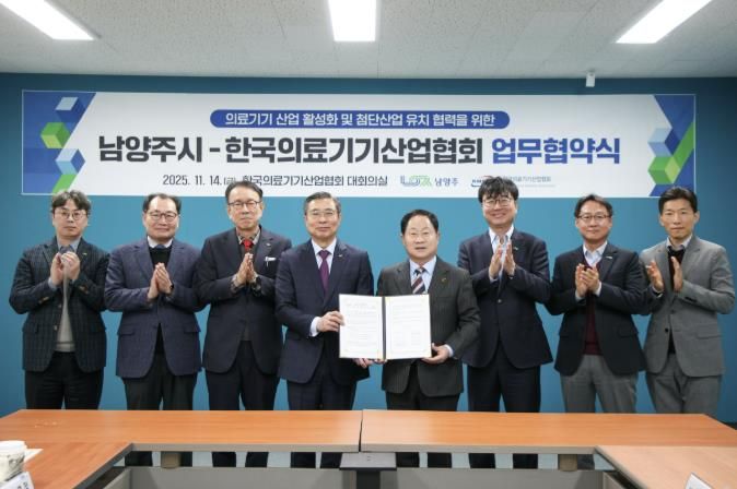 양 측 관계자가 협약서와 함께 단체사진을 촬영하고 있다